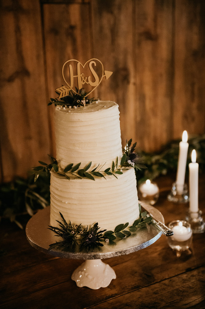 Two Tier Wedding Cake Adorned With Green Foliage Decoration