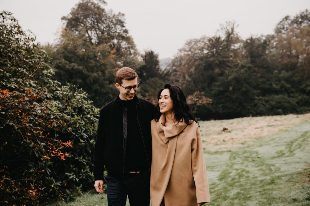 Couple Walk Together on Outdoor Engagement Shoot at Ashdown Park Hotel