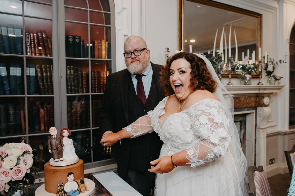Couple Cut the Wedding Cake - Oatlands Park Hotel Wedding
