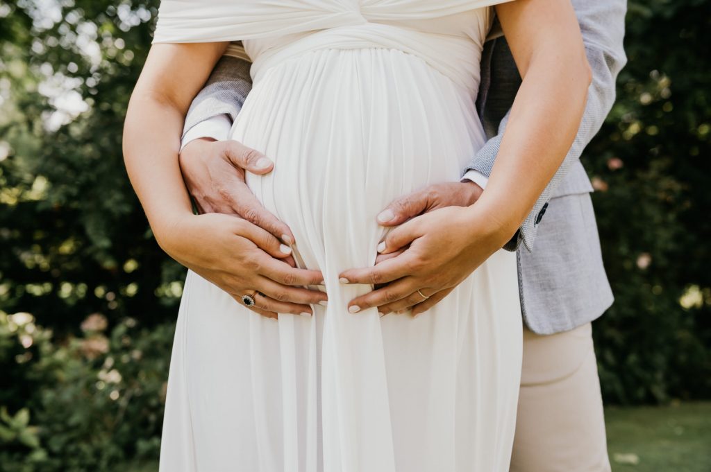 Glowing Pregnant Bride and Newley Wed Husband Embrace
