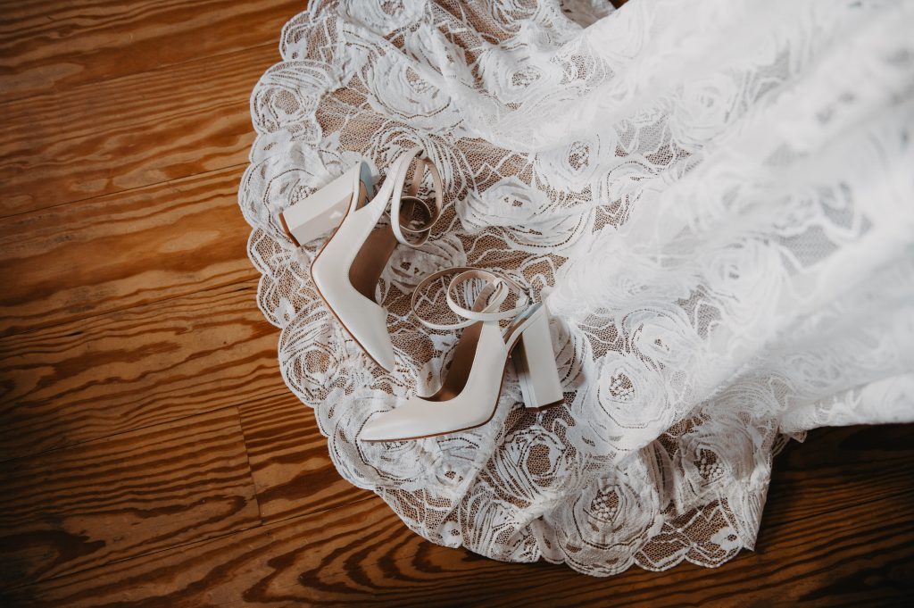 Wedding shoes creatively displayed on wedding dress train