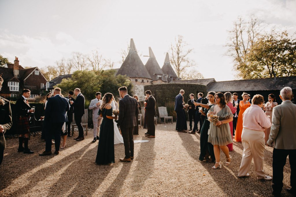 Bury Court Barn Venue Exterior - Guests Have Drinks and Canapés During Reception 