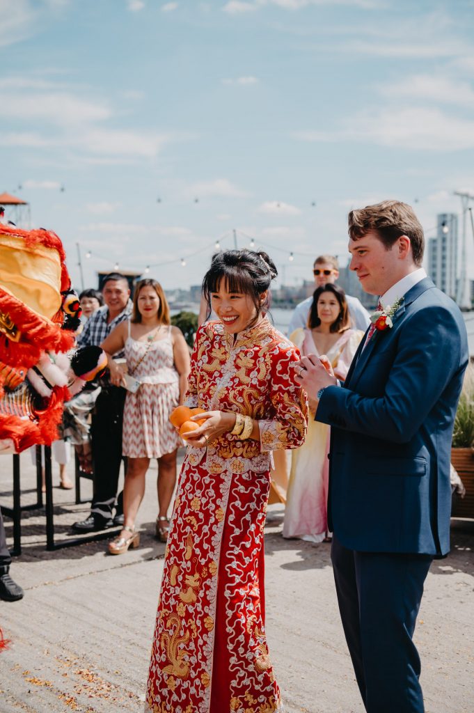 Couple Watch Dragon Dance During Chinese Wedding Day Tradition - London Wedding Photography