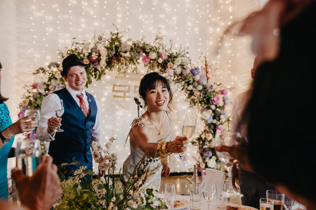 Couple Cheers After Speeches - London Wedding Photography