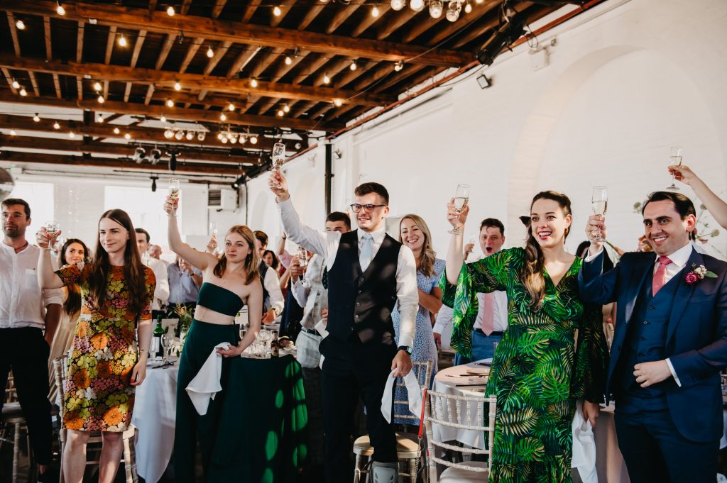 Guests Cheers as Wedding Couple Enter - Trinity Buoy Wharf Wedding