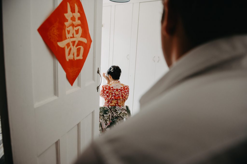 Bride Hides Away Listening to Husbands Declaration of Love During Chinese Door Games - London Wedding Photography
