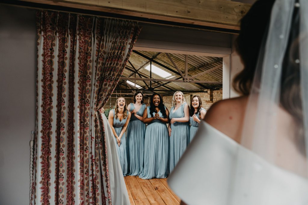 Bridesmaids reaction to seeing bride in her outfit for the first time - The Barn At Botley Hill Wedding
