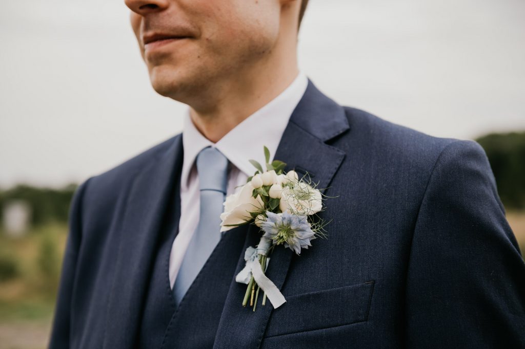 Simple and delicate white button hole - Surrey wedding photography