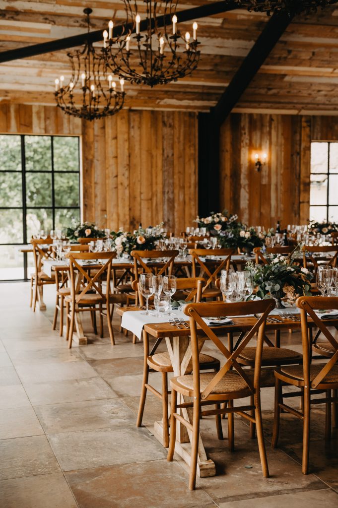 Rustic Wedding table decor with light peach flowers and eucalyptus foliage. 