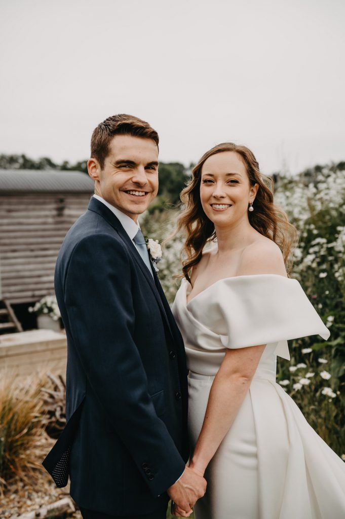 Couple smile to the camera during couples portraits at Botley Hill Barn Wedding