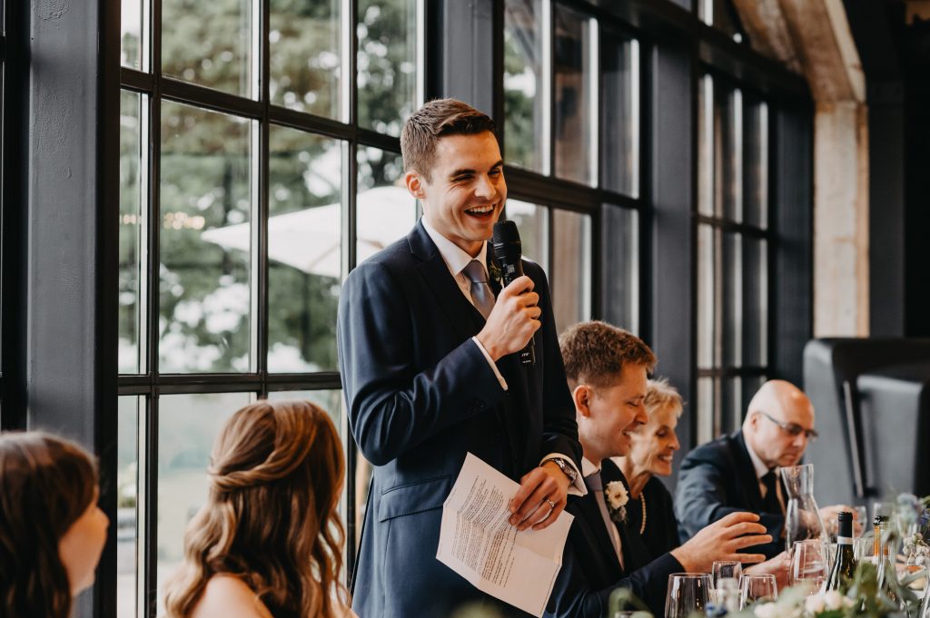 Candi groom reactions during speech at Botley Hill Barn wedding.