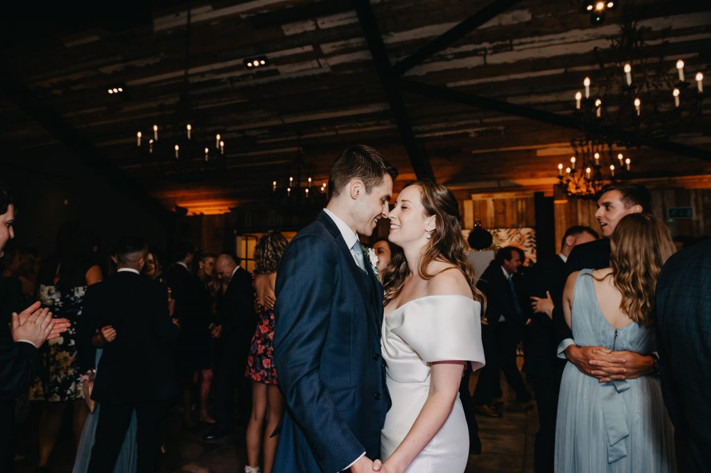 Fun first dance wedding photography at Botley Hill Barn wedding. Couple share an intimate moment on the dance floor together.