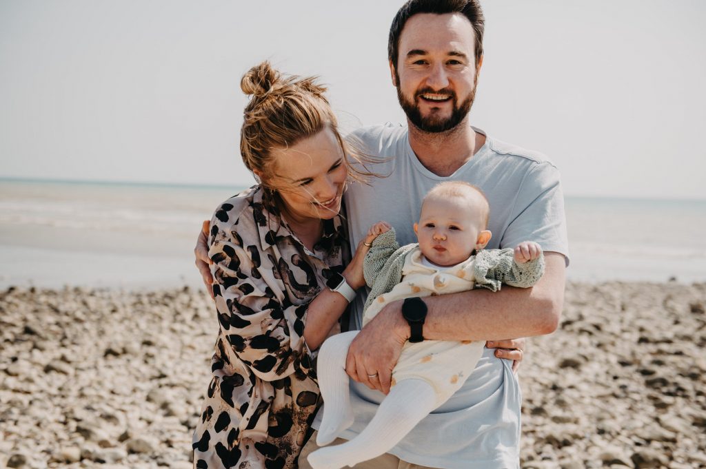 Fun and Candid Newborn Family Portrait on The Beach