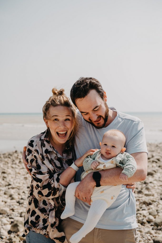 Fun and Candid Newborn Family Portrait on The Beach