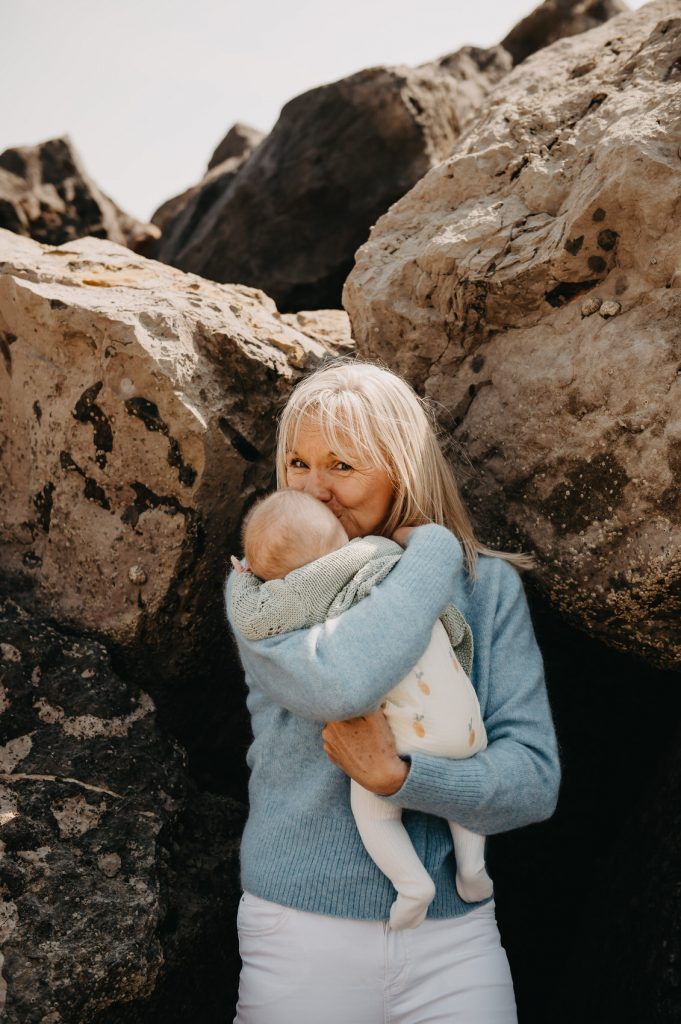 Grandmother Shares Snuggly Portrait Photograph with Granddaughter - Sussex Beach Family Shoot 