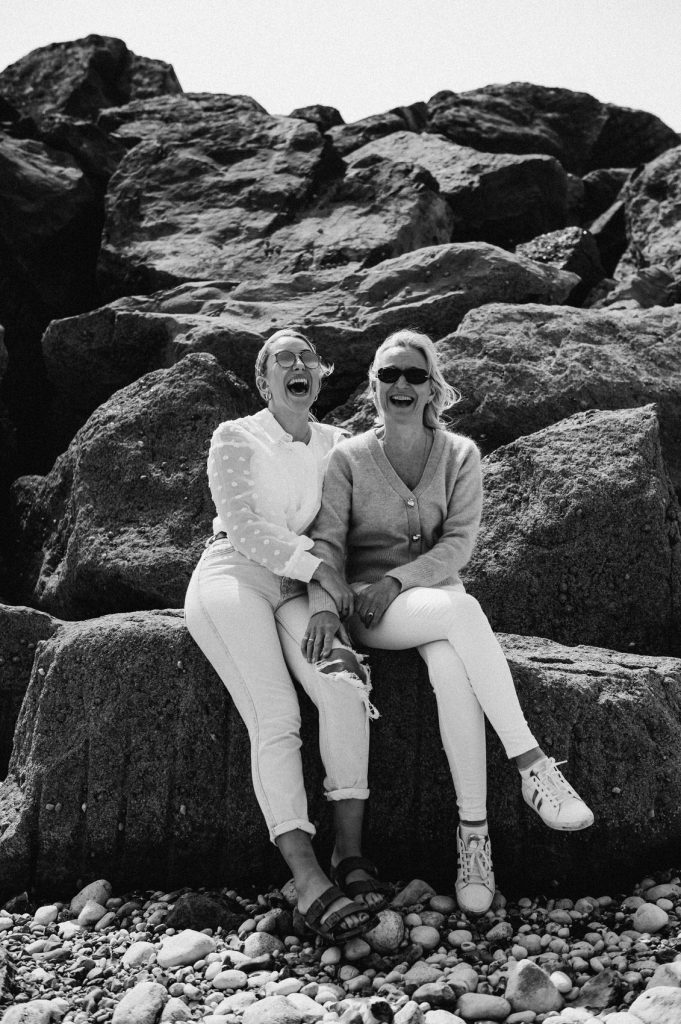 Fun Mother and Daughter Portrait Upon Beach Rocks