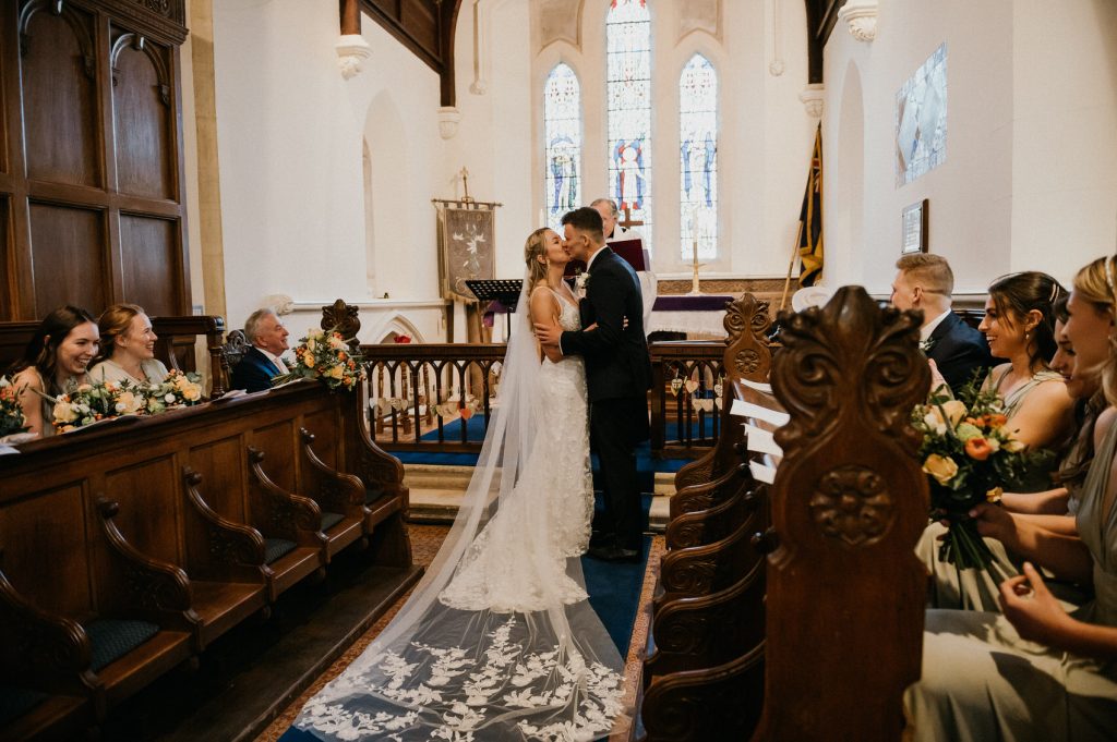 Wedding Couple Share First Kiss During Church Ceremony