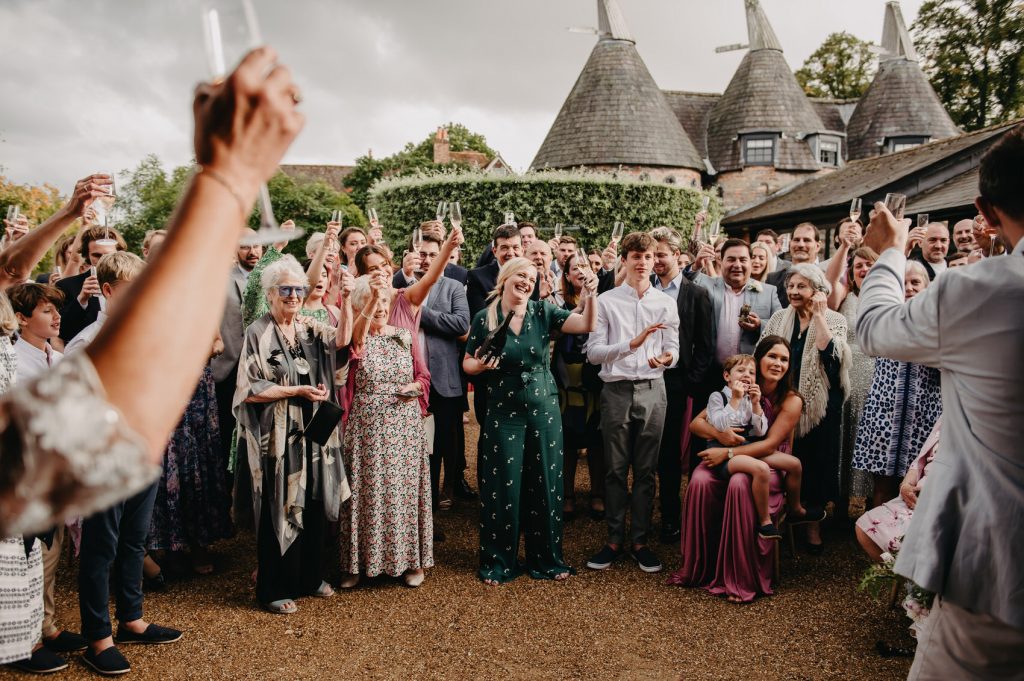 Wedding at Bury Court Barn, Wedding Guests Have Speeches Outside in Courtyard
