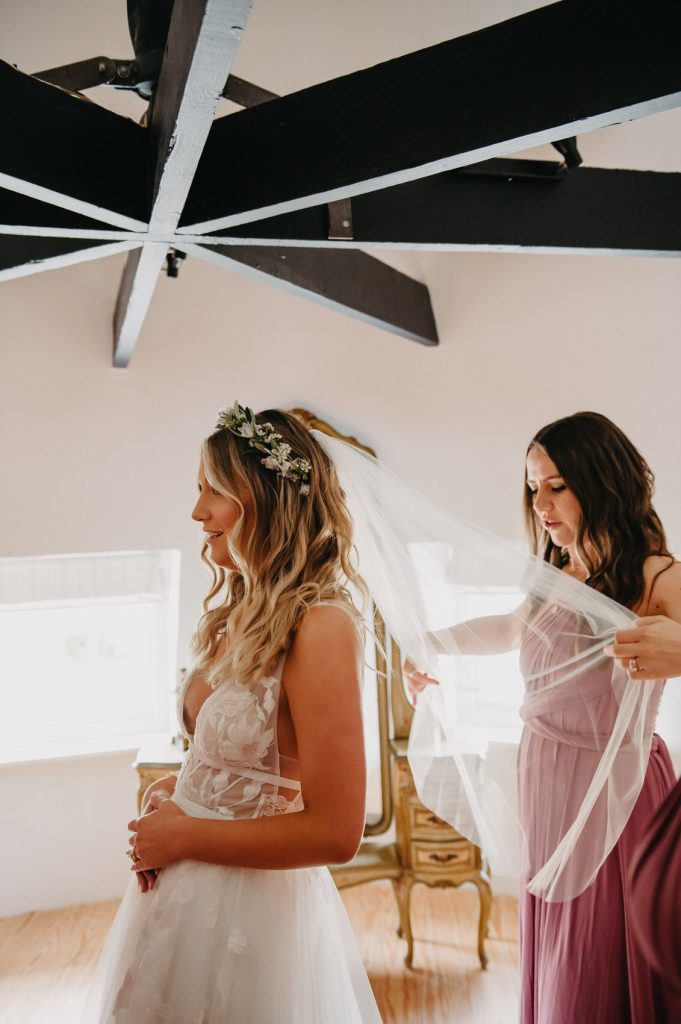 Bridesmaid Helps With Veil Arrangement - Wedding at Bury Court Barn