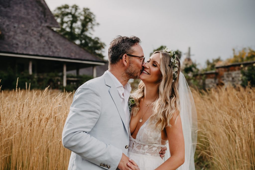 Relaxed and Romantic Wedding Portrait in Fields of Bury Court Barn