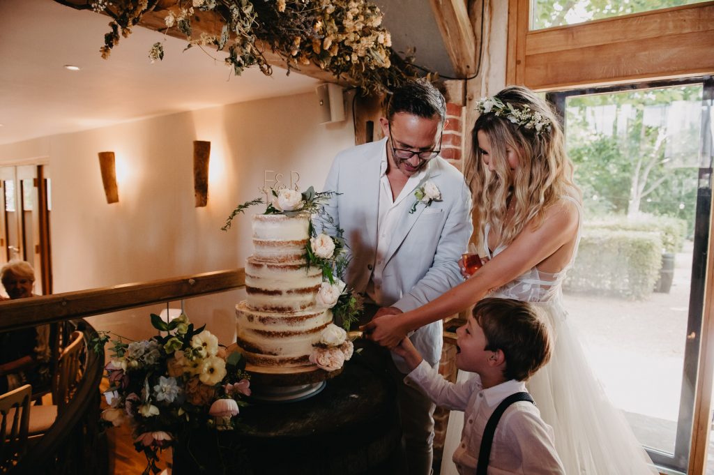 Couple Cut Wedding Cake - Fun Wedding Photography