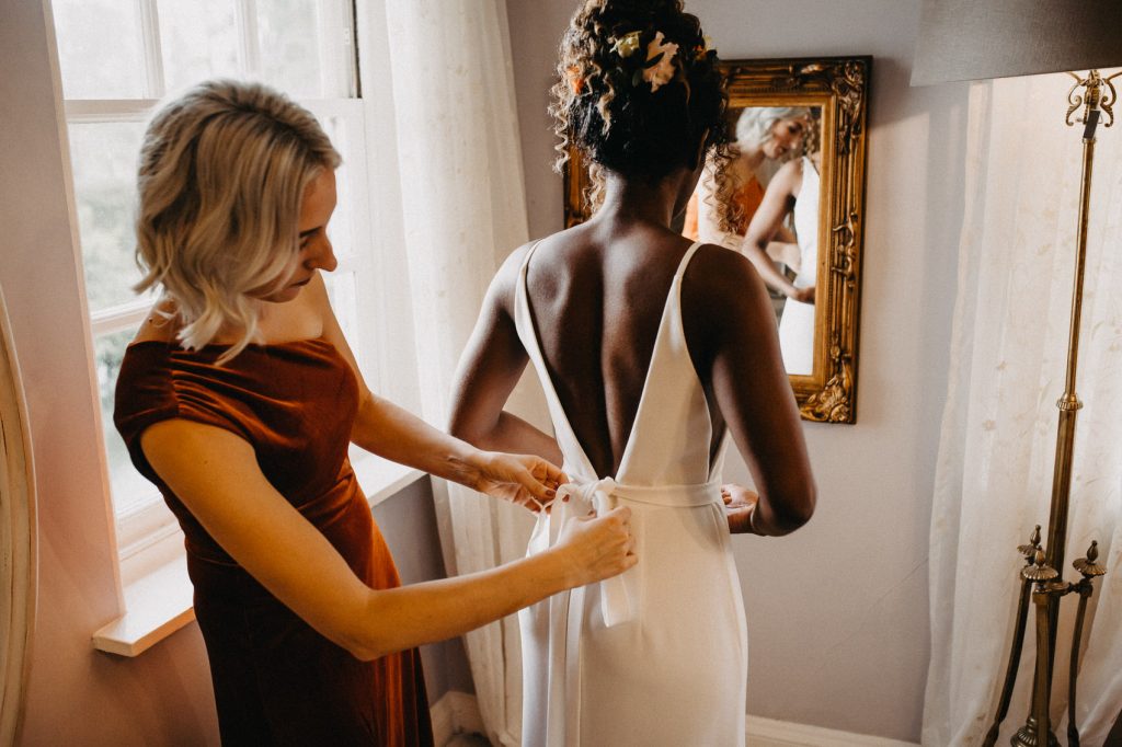 Bride is Helped into Wedding Dress on Morning Of Wedding