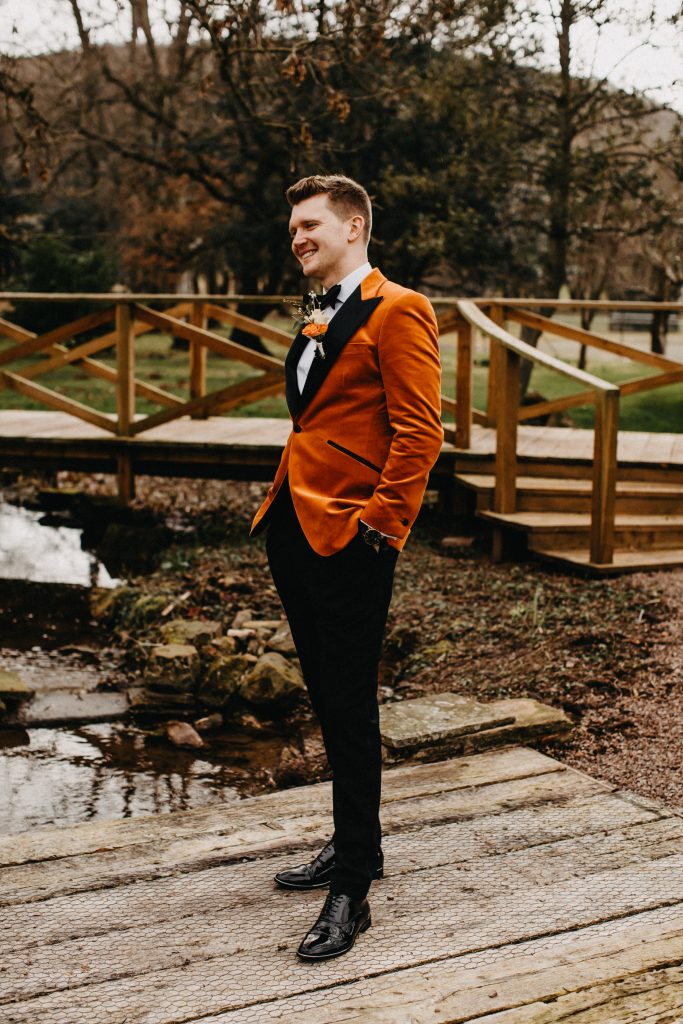 Groom Wears Burnt Orange Velvet Wedding Suit Jacket for Winter Wedding