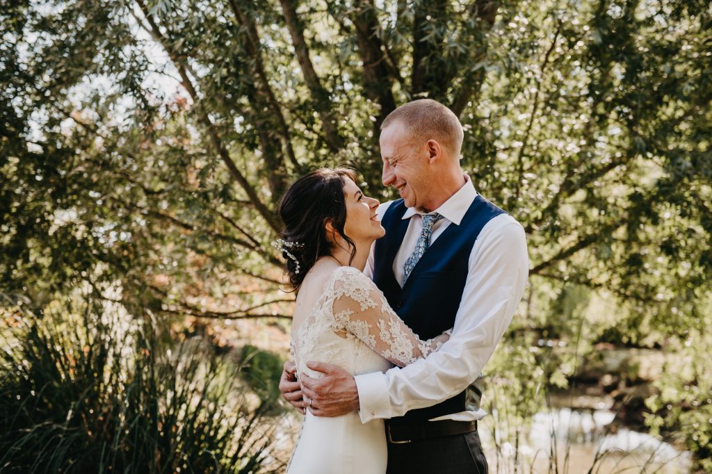 Couple Share a Cuddle During Couples Portraits - Rumbolds Farm Wedding