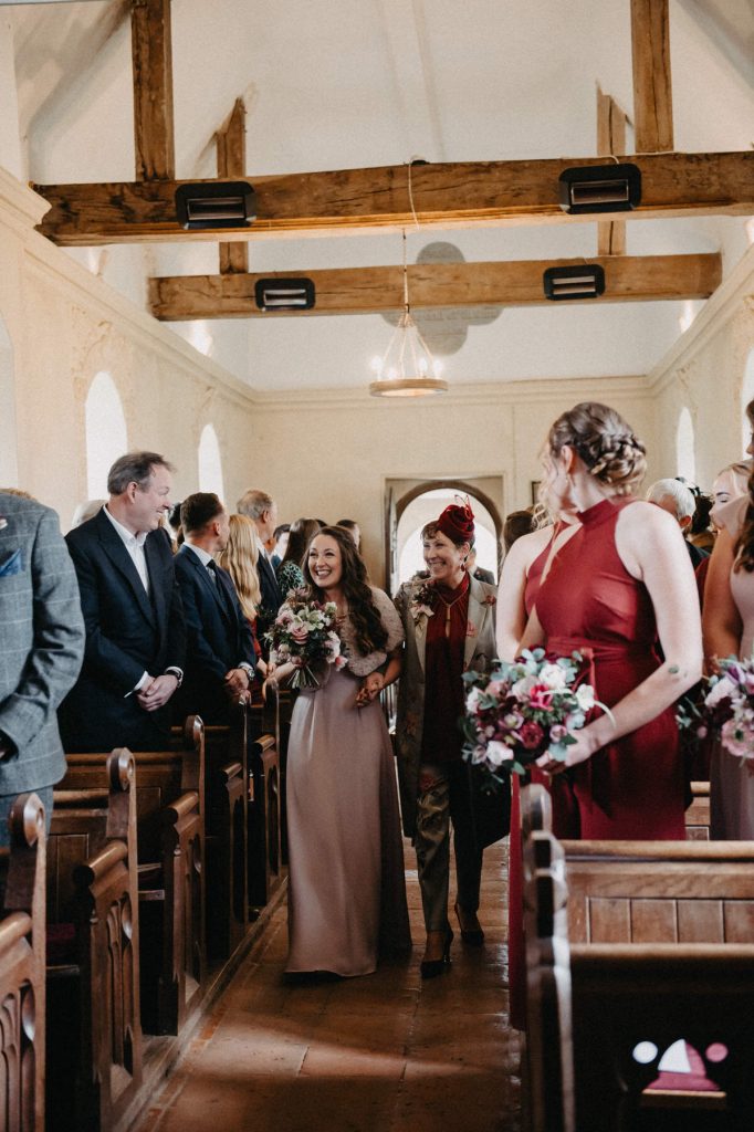 Bridesmaids Walk Down the Aisle in Intimate Church Wedding