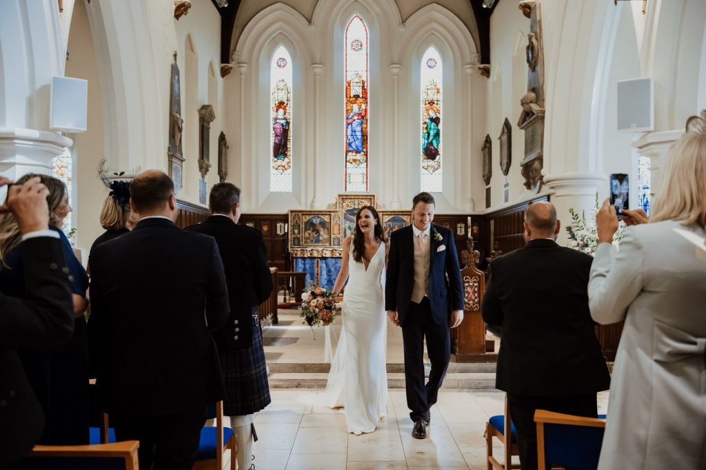Wedding Couple Leave Ceremony as Married Couple - Surrey Wedding Photography