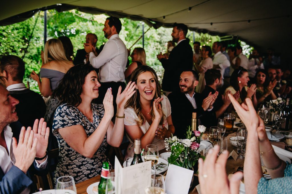 Guests Cheer at Couples Wedding Entrance - Outdoor Surrey Marquee Wedding