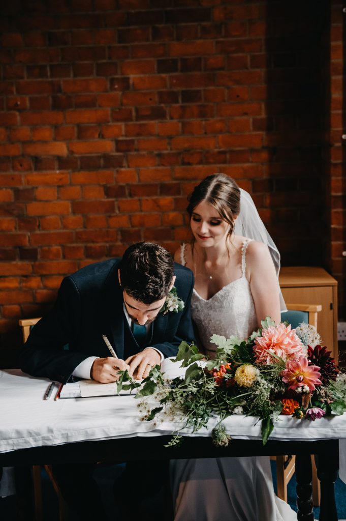 Couple Sign The Register - Church Wedding Photography