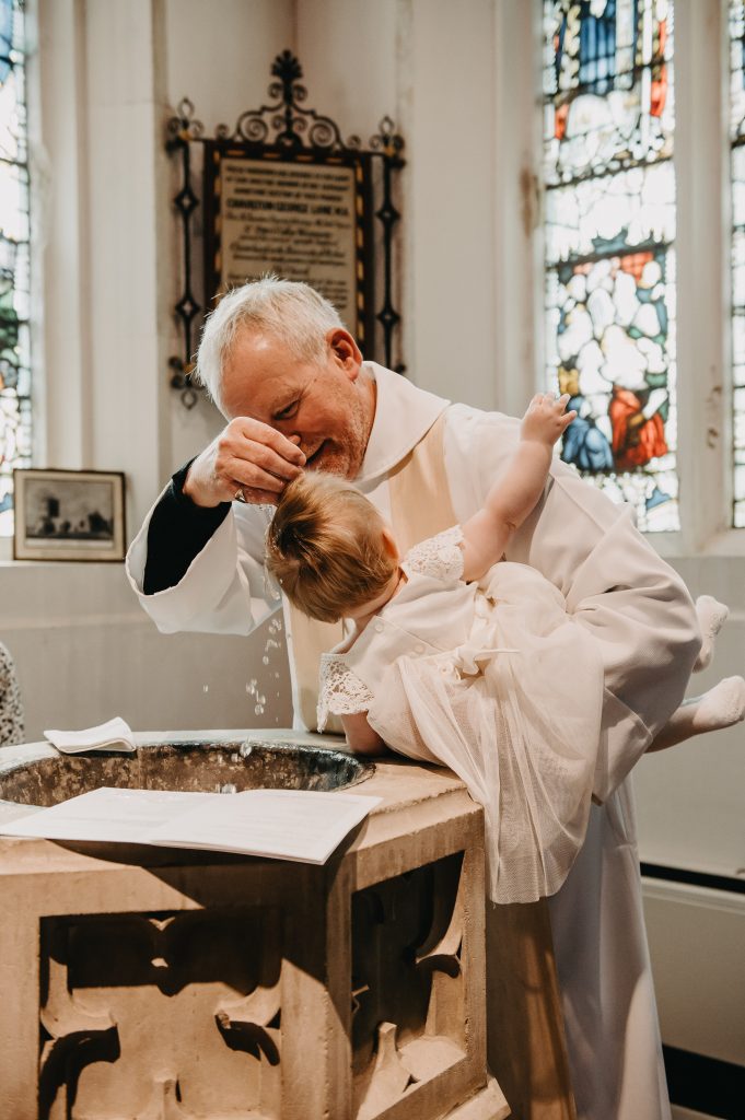 Vicar Performs Christening Holy Water Ceremony 