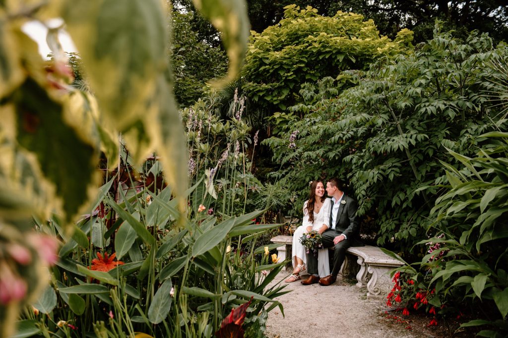 Couple Sit in the Tropical Garden at RHS Wisley Gardens