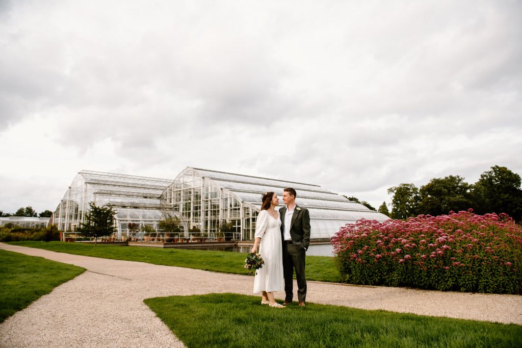 Couples Kiss In Front of The Glasshouse at RHW Wisley Gardens