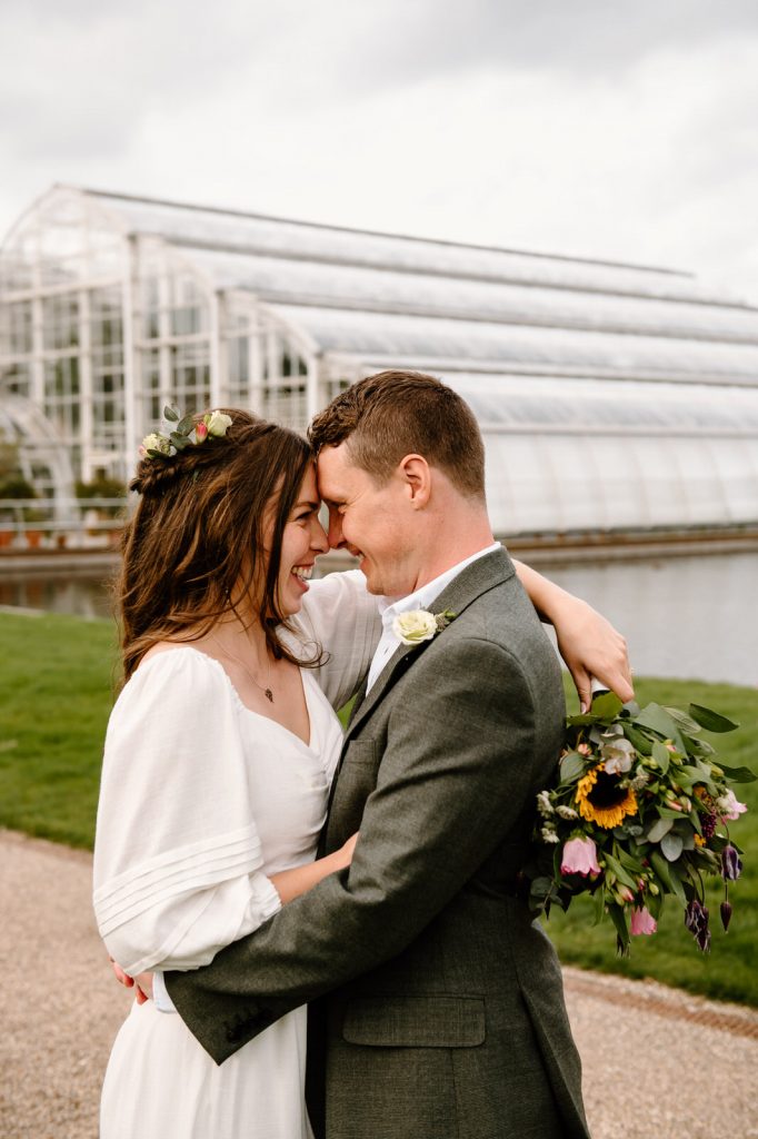 Couples Embrace In Front of The Glasshouse at RHW Wisley Gardens