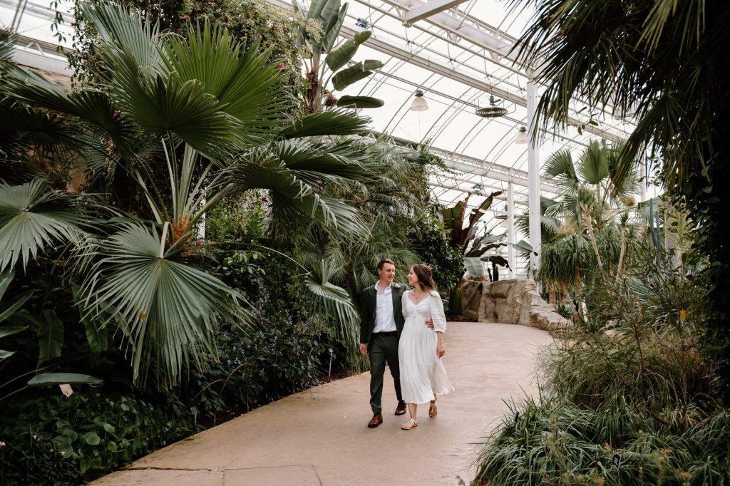 Natural and Candid Wedding Portrait - Couple Walk Together in Tropical Glasshouse 
