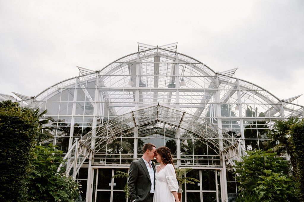 Couple Embrace Outside of Tropical Glasshouse at RHS Wisley Gardens 
