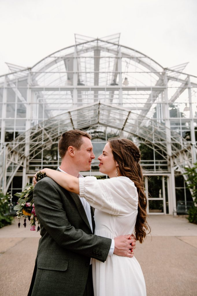 Couple Embrace Outside of Tropical Glasshouse at RHS Wisley Gardens 