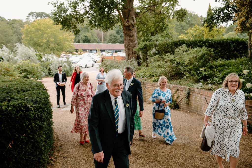 Guests Arrive For Wisley Garden Wedding