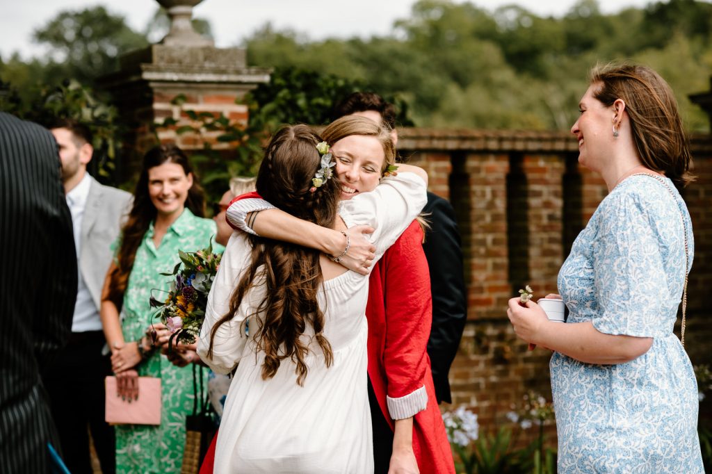 Guests Embrace The Couple Before Wedding Ceremony - Surrey Wedding Photography