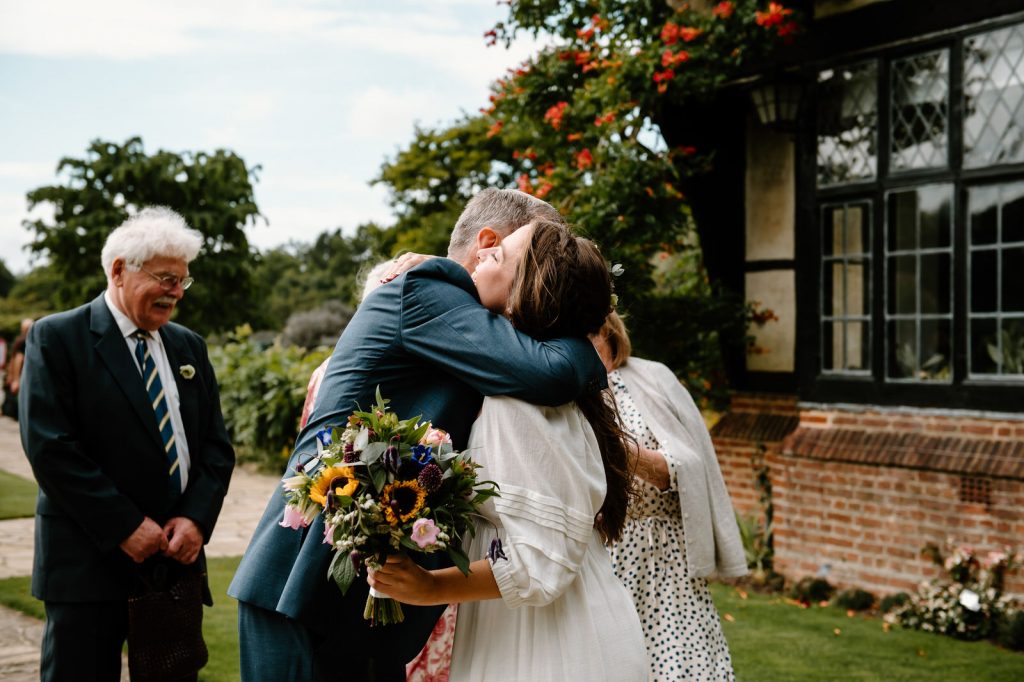 Guests Embrace The Couple Before Wedding Ceremony - Surrey Wedding Photography