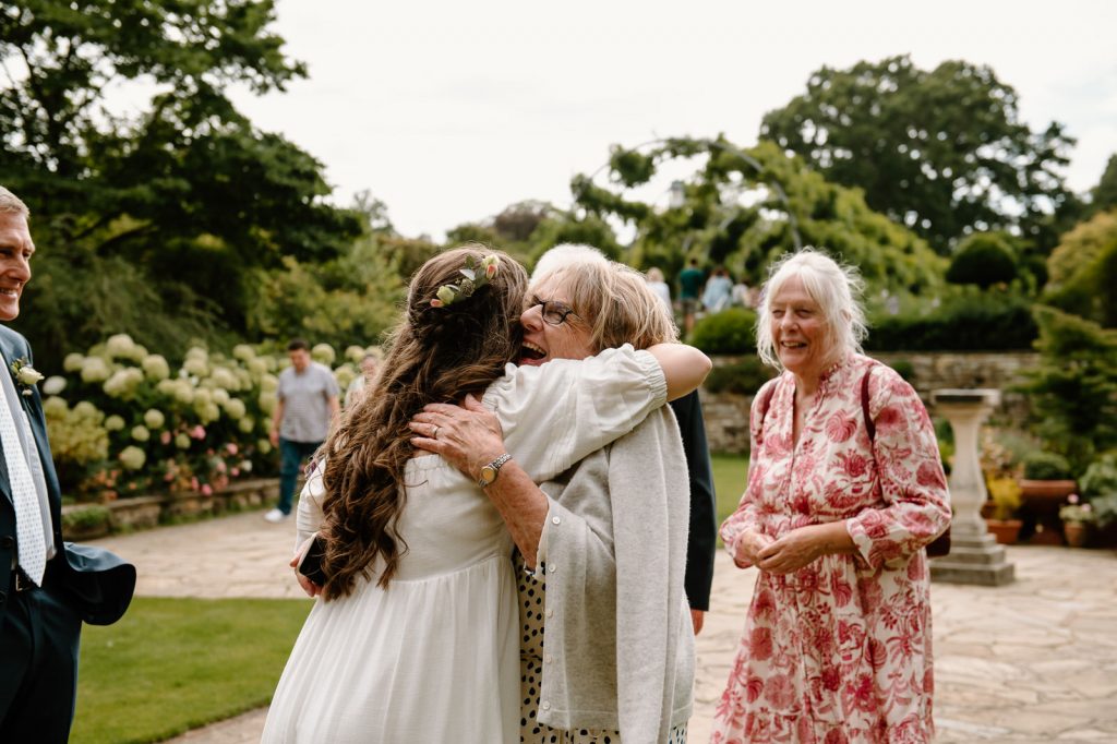 Grandmother Embrace The Couple Before Wedding Ceremony - Surrey Wedding Photography