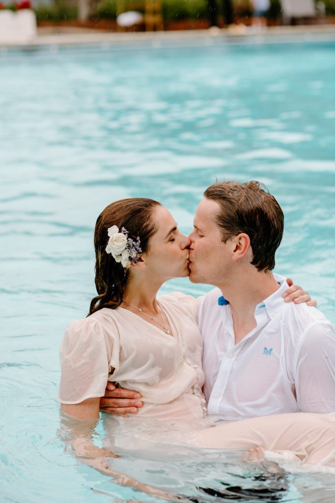 Fun and Spontaneous Couple Kiss as They Swim in Their Outfits