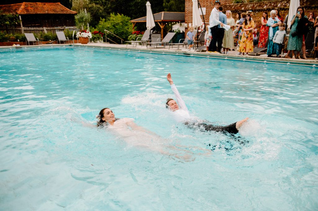 Couple Swim Together at Their Wedding - Great Fosters Surrey
