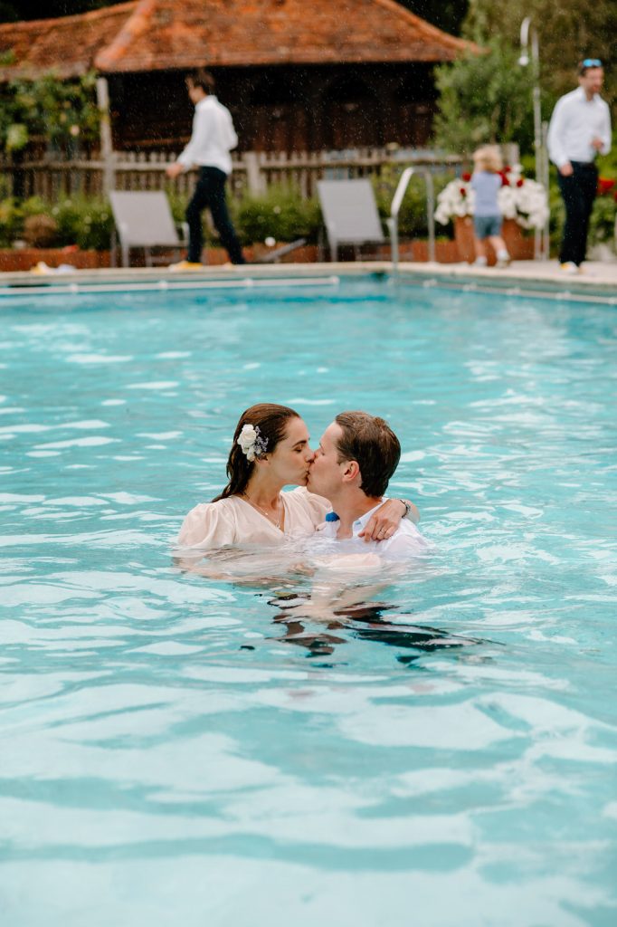 Fun and Spontaneous Wedding - Couple Kiss as They Swim in Their Wedding Outfits
