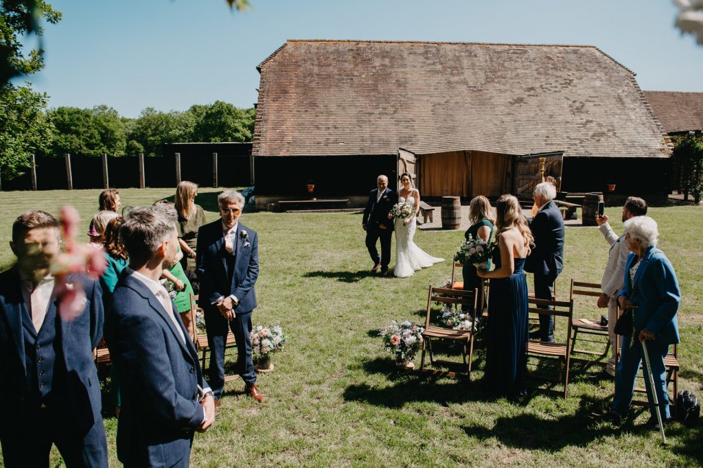 Arrival of The Bride and Her Father for Outdoor Ceremony at Gildings Barn Wedding