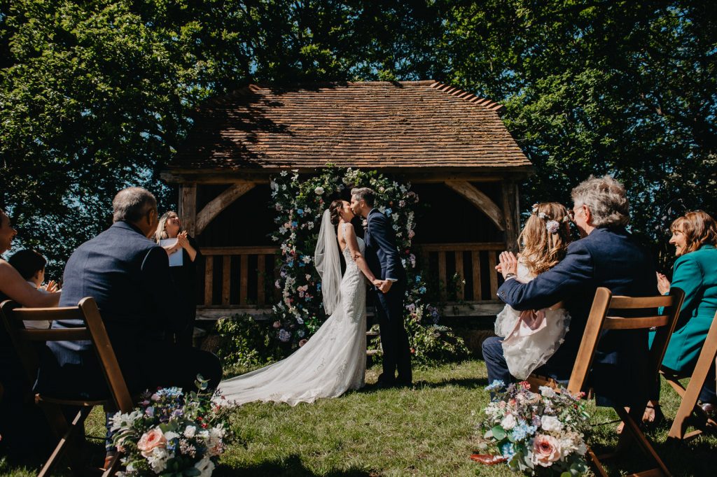 Couple Share First Kiss During Outdoor Ceremony