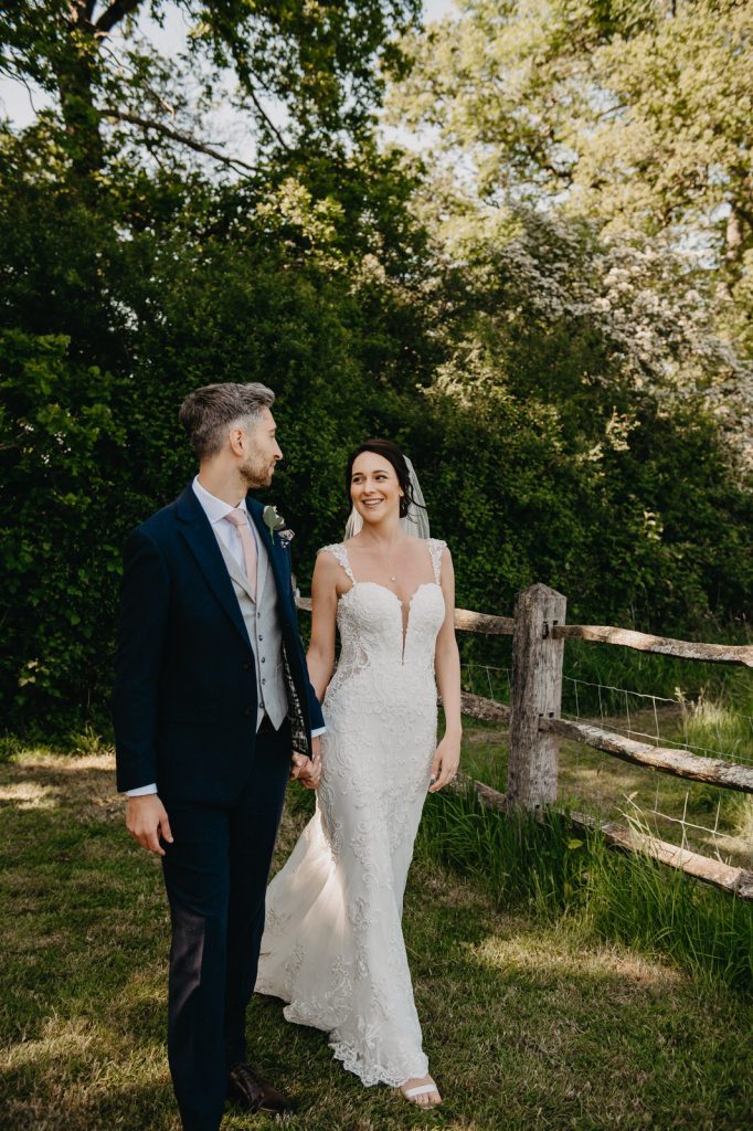 Newley Wed Couple Walk Together - Gildings Barn Wedding