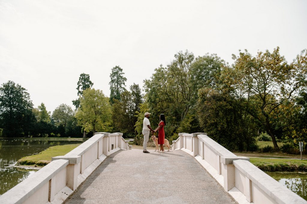Couple Stand Together on The Bridge in Painshill Park